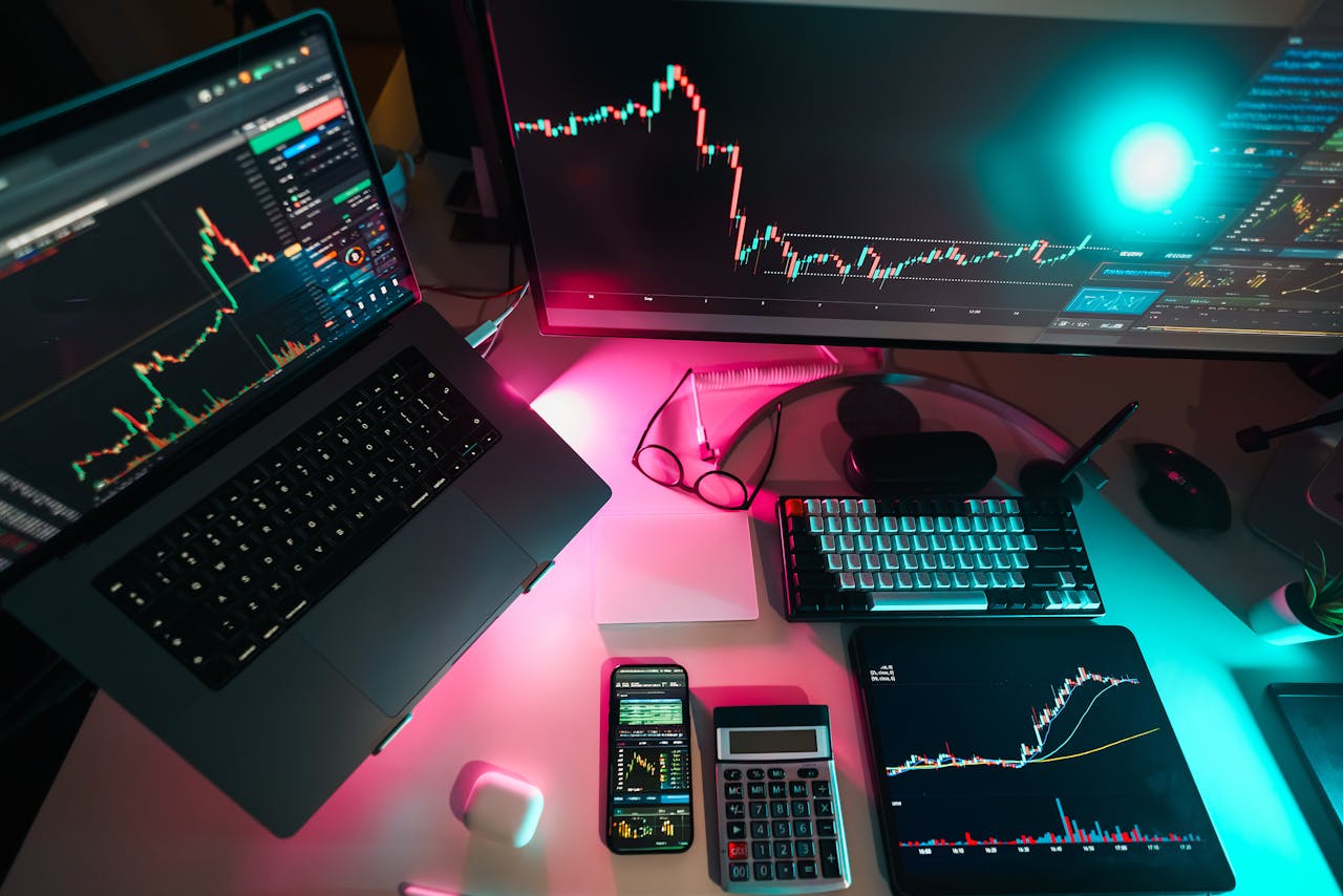 why-choose-us High-tech trading setup featuring digital charts on multiple devices, ideal for finance professionals.